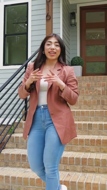 Realtor walking down the brick steps of a new home